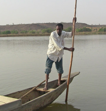 A fisherman embarks on a sunset trip down the Niger River valley on board his only source of income, a pirogue, a wooden canoe made of hollowed tree trunks, usually used for transport, fishing and hunting activities. Photo by: Linda Leila Diatta.