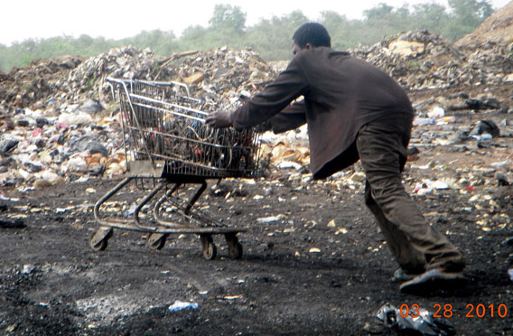  A boy pushing a shopping cart load of wires going for burning in the Agbogbloshie ghetto in Accra, Ghana. Photo by: Kwei Quartey.