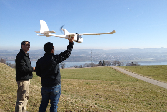 Koh and Wich testing their drone in Switzerland. The conservation drone has been equipped with various cameras including the GoPro HD Hero, the Canon IXUS 220 HS, and the Pentax Optio WG-1 GPS. Image courtesy of Lian Pin Koh. 