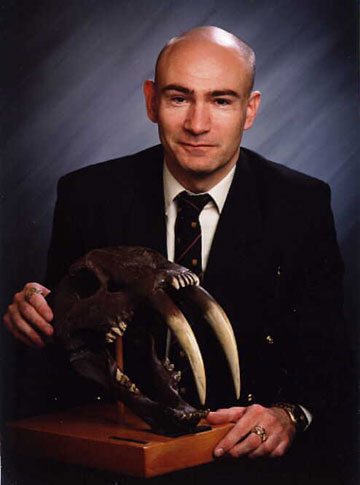 Shuker with the skull of the extinct smilodon. Photo courtesy of Karl Shuker.