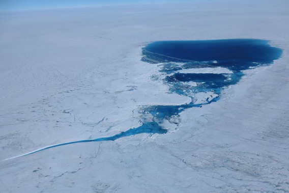 A supraglacial lake over the Greenland ice sheet in the Kangerlussuaq area at 1500 m elevation photographed on July 21, 2012. The lake feeds a stream that will deliver meltwater to the low elevations where it will either flow to the ocean on the surface or it will dive into the ice to contribute to the development of the englacial hydrological system. Photo by:  Marco Tedesco.