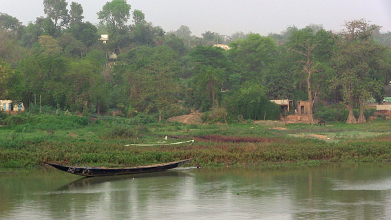 Delimited by dense vegetation and a vivid green tree-lined riverfront, the livelihood of this remote fishermen village strongly depends on the Niger River—the only permanent water source and fertile area in the country. Photo by: Linda Leila Diatta.