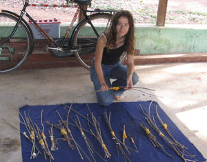 Tranquilli with chimpanzee tools. Photo courtesy of Sandra Tranquilli.