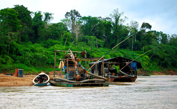 Illegal gold mining boat in Peru. Photo courtesy of Katy Ashe.