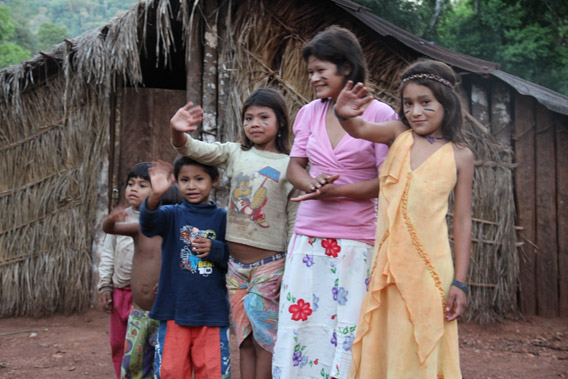 Guarani family welcomes John Burton (WLT CEO) to their village the day after he signs the Multicultural Alliance, they later sing a traditional song in thanks. Photo by: WLT.